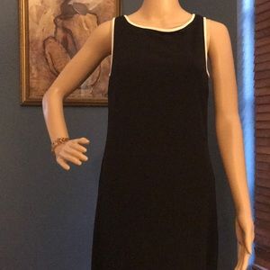 Black dress with white trim.